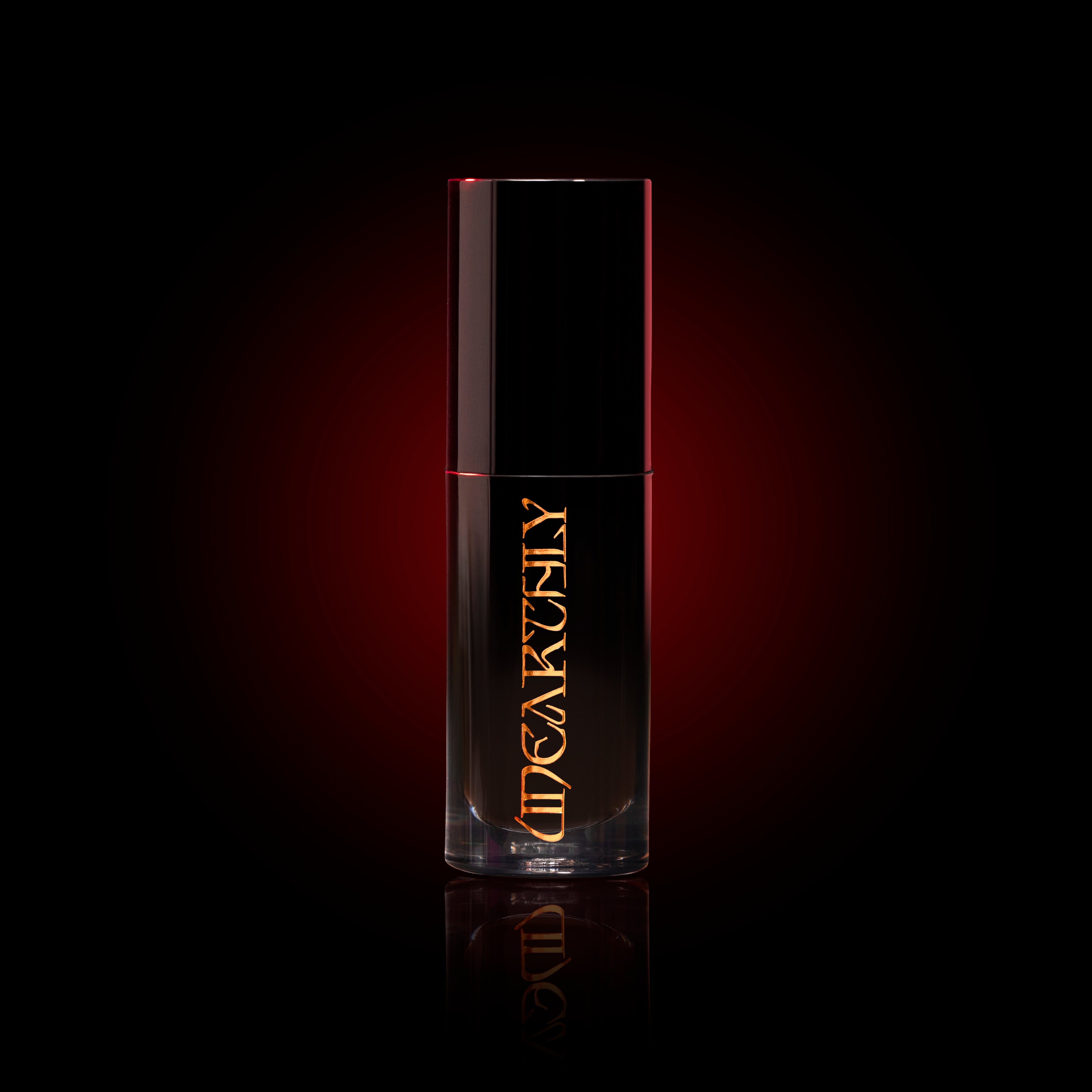 Black lip oil gothic cosmetics on black backdrop